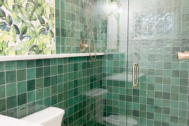 Alcove shower - small modern master green tile and ceramic tile ceramic tile, white floor and single-sink alcove shower idea in Kansas City with flat-panel cabinets, beige cabinets, a two-piece toilet, green walls, an undermount sink, quartz countertops, a hinged shower door, white countertops, a niche and a floating vanity