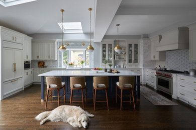 Inspiration for a large transitional galley medium tone wood floor and brown floor enclosed kitchen remodel in Chicago with a double-bowl sink, shaker cabinets, white cabinets, marble countertops, multicolored backsplash, cement tile backsplash, white appliances, an island and white countertops