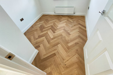 Medium sized modern guest bedroom in Gloucestershire with dark hardwood flooring.