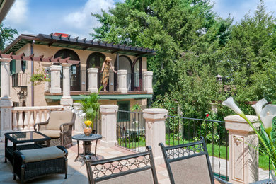 Tuscan beige stucco house exterior photo in Boston with a hip roof and a tile roof