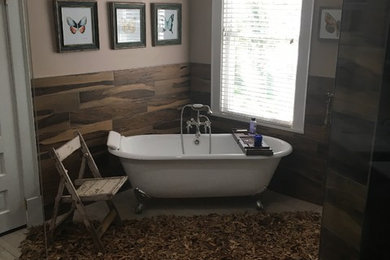 Bathroom - large rustic master brown tile and porcelain tile gray floor and porcelain tile bathroom idea in Other with furniture-like cabinets, dark wood cabinets, a one-piece toilet, an undermount sink, marble countertops, a hinged shower door and beige walls