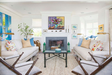 Beach style medium tone wood floor and brown floor living room photo in Chicago with white walls and a standard fireplace