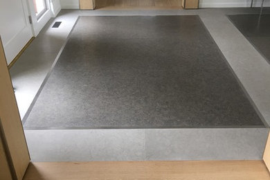 Inspiration for a mid-sized contemporary limestone floor entryway remodel in New York with white walls and a white front door