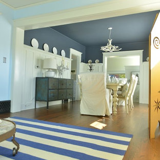 Exemple d'une salle à manger ouverte sur la cuisine craftsman de taille moyenne avec un mur bleu et un sol en bois brun.
