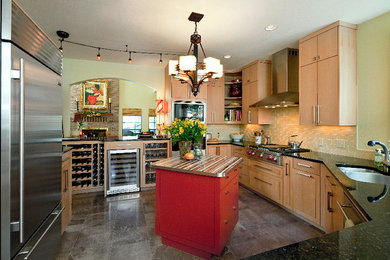 Inspiration for a mid-sized transitional u-shaped kitchen remodel in Austin with a double-bowl sink, flat-panel cabinets, light wood cabinets, granite countertops, beige backsplash, ceramic backsplash, stainless steel appliances and an island