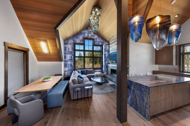 Example of a large trendy open concept medium tone wood floor, brown floor, exposed beam and wallpaper living room design in Other with white walls, a wood stove and a concrete fireplace