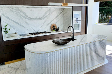Photo of a modern single-wall kitchen in Sydney with an undermount sink, marble benchtops, white splashback, marble splashback, marble floors, with island, white floor and white benchtop.