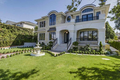 Large contemporary multicolored three-story stucco exterior home idea in Vancouver with a shingle roof