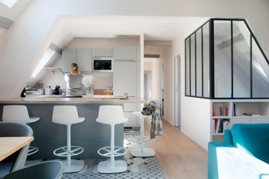 This is an example of a large contemporary u-shaped eat-in kitchen in Other with beige splashback, cement tiles, grey floor and beige benchtop.