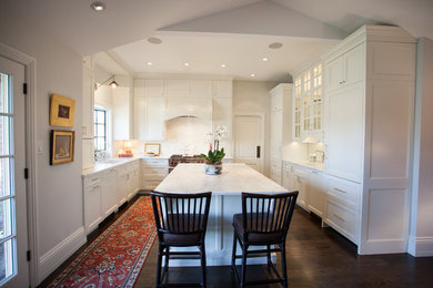 Mid-sized transitional u-shaped kitchen photo in Denver with recessed-panel cabinets, white cabinets, marble countertops, white backsplash, stone slab backsplash, paneled appliances and an island