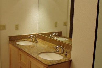 Bathroom - mid-sized contemporary master beige tile and porcelain tile porcelain tile, beige floor and double-sink bathroom idea in San Francisco with an undermount sink, granite countertops, a built-in vanity, recessed-panel cabinets, brown cabinets, a two-piece toilet and white walls