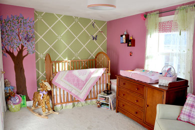 Inspiration for a mid-sized timeless girl carpeted nursery remodel in Boston with multicolored walls