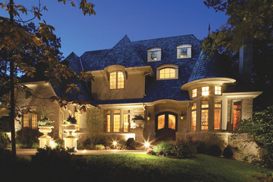 Large elegant beige two-story mixed siding exterior home photo in Houston