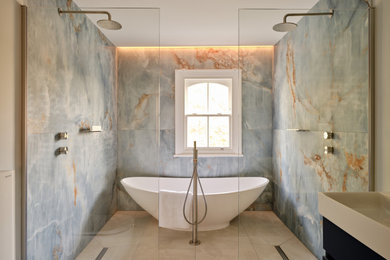 This is an example of a large classic bathroom in London with blue cabinets, a freestanding bath, blue tiles, blue walls, ceramic flooring, a trough sink, an open shower, a single sink and a freestanding vanity unit.