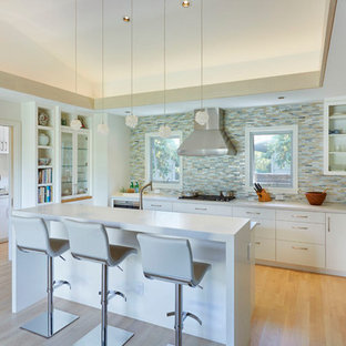 Свежая идея для дизайна: п-образная кухня среднего размера в восточном стиле с кладовкой, плоскими фасадами, белыми фасадами, разноцветным фартуком, полом из бамбука, островом и коричневым полом - отличное фото интерьера