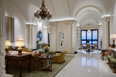 Example of a classic formal marble floor living room design in Miami with white walls