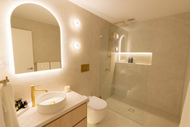 Photo of a mid-sized modern 3/4 bathroom in Sydney with flat-panel cabinets, light wood cabinets, engineered quartz benchtops, grey benchtops, a single vanity and a floating vanity.
