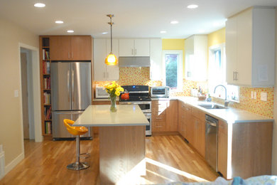 Inspiration for a contemporary l-shaped light wood floor eat-in kitchen remodel in Boston with an undermount sink, flat-panel cabinets, light wood cabinets, quartz countertops, orange backsplash, glass tile backsplash, stainless steel appliances and an island