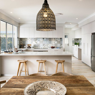 Large beach style kitchen pantry remodeling - Example of a large coastal u-shaped ceramic floor kitchen pantry design in Perth with an undermount sink, flat-panel cabinets, light wood cabinets, quartz countertops, multicolored backsplash, ceramic backsplash, stainless steel appliances and no island