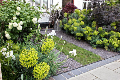 This is an example of a medium sized rural front driveway garden in London.