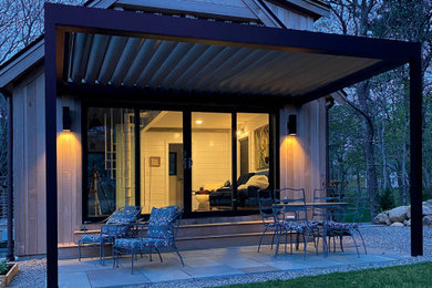 Mid-sized courtyard concrete patio photo with a fire pit and a pergola