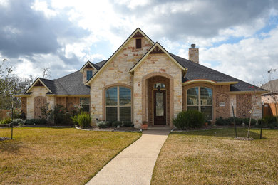 Mid-sized elegant one-story concrete gable roof photo in Austin