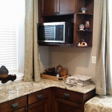 Cabinets.com | Unique Kitchen with Dark Stained Cabinetry and Bench Seating