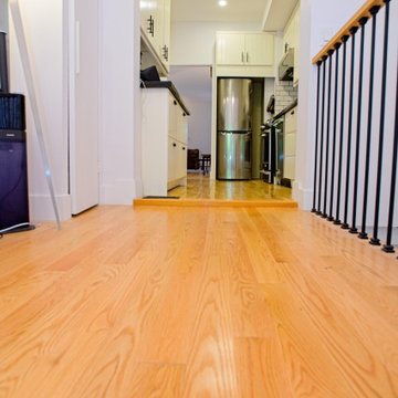 Warm Wood Flooring Connecting the Kitchen and Stair Area | East York