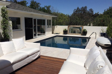 This is an example of a small backyard custom-shaped pool in Los Angeles with tile.