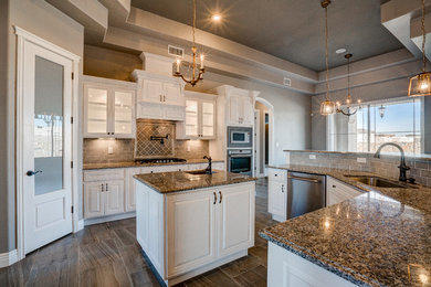Mid-sized elegant ceramic tile kitchen photo in Austin with a single-bowl sink, raised-panel cabinets, white cabinets, granite countertops, brown backsplash, subway tile backsplash and an island