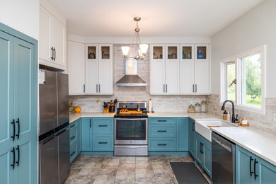 Inspiration for a mid-sized transitional u-shaped kitchen remodel in Other with a farmhouse sink, shaker cabinets, blue cabinets, quartz countertops, stainless steel appliances and white countertops