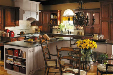 Large elegant l-shaped light wood floor eat-in kitchen photo in Other with an undermount sink, raised-panel cabinets, dark wood cabinets, gray backsplash, stainless steel appliances and an island