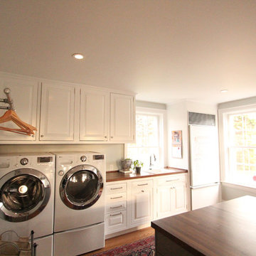 Side by Side Washer and Dryer in Large Mudroom with Walnut Countertop