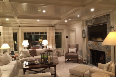 Living room - large traditional formal and enclosed dark wood floor living room idea in New York with beige walls, a standard fireplace, a stone fireplace and a wall-mounted tv
