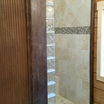 Glass block finished end blocks in an open rustic shower