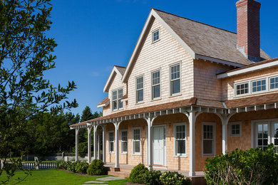 Example of an ornate two-story wood exterior home design in Boston
