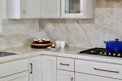 Inspiration for a mid-sized contemporary l-shaped medium tone wood floor open concept kitchen remodel in San Francisco with an undermount sink, shaker cabinets, quartzite countertops, beige backsplash, marble backsplash, stainless steel appliances, an island and beige countertops