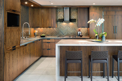 Inspiration for a mid-sized contemporary l-shaped kitchen in San Diego with an undermount sink, flat-panel cabinets, dark wood cabinets, marble benchtops, brown splashback, terra-cotta splashback, panelled appliances, marble floors and with island.