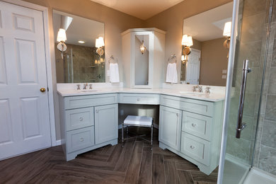 This is an example of a mid-sized traditional master bathroom in Bridgeport with an undermount sink, recessed-panel cabinets, grey cabinets, engineered quartz benchtops, a freestanding tub, a corner shower, a two-piece toilet, gray tile, porcelain tile, grey walls and porcelain floors.