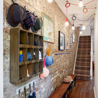 Design ideas for a small bohemian boot room in London with dark hardwood flooring.