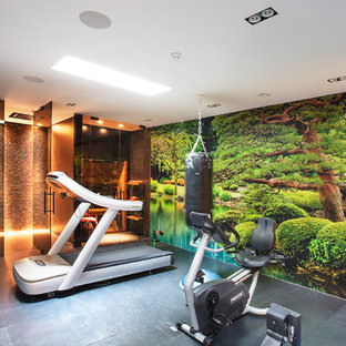 Photo of a modern multi-use home gym in London with multi-coloured walls and grey floors.