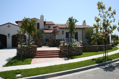 Example of a large tuscan white two-story stucco exterior home design in Los Angeles