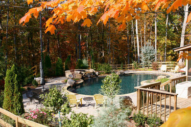 Pool fountain - traditional backyard concrete paver and custom-shaped pool fountain idea in Atlanta