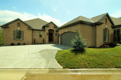 Inspiration for a mid-sized transitional one-story brick exterior home remodel in Cincinnati with a hip roof
