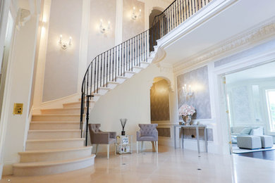Design ideas for a classic curved wood railing staircase in Other with limestone treads and limestone risers.
