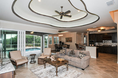 Inspiration for a large mediterranean open concept ceramic tile and beige floor living room remodel in Miami with beige walls