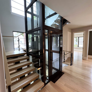 Project #136 | Modern Floating Staircase Encircling Glass Elevator