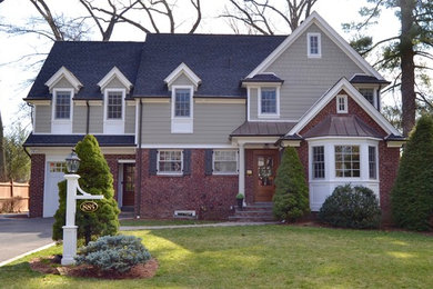 Example of a classic beige two-story concrete fiberboard exterior home design in New York