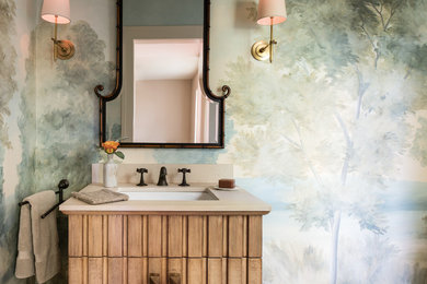 Inspiration for a mid-sized eclectic medium tone wood floor powder room remodel in San Francisco with light wood cabinets, a one-piece toilet, blue walls and an undermount sink