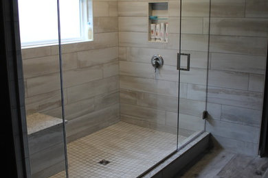 Example of a large transitional master gray tile and ceramic tile cement tile floor and gray floor doorless shower design in Cleveland with gray walls and a hinged shower door